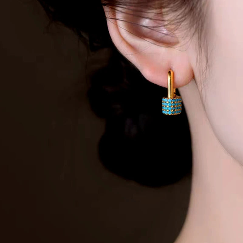 Model showcasing the dangle and style of the 14K Gold-Plated U-Shaped Ear Buckle Earrings