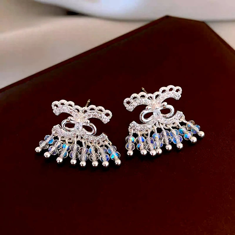 Model showcasing the dangle and style of the 14K Gold-Plated Versatile Commuting Earrings