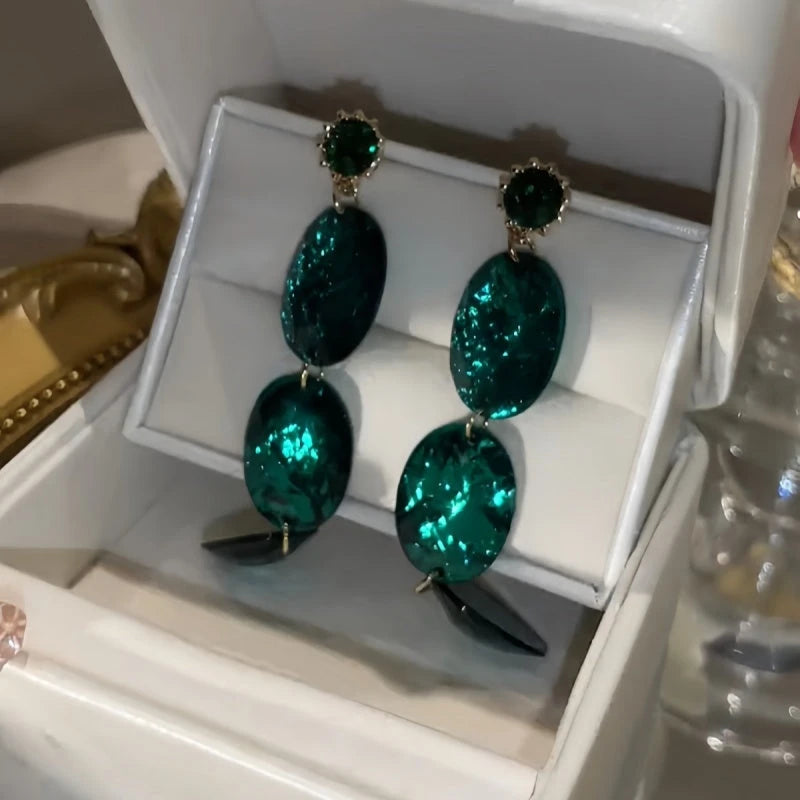 Close-up detail of the sparkling zircons and plating on the Emerald Oval Earrings