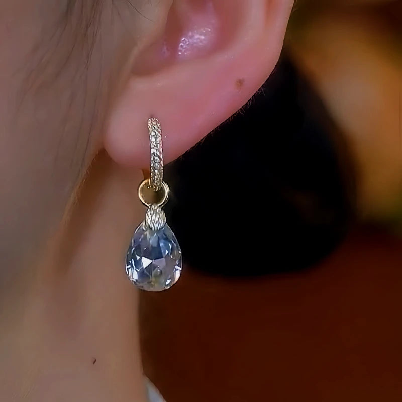 Model showcasing the dangle and style of the 14K Gold-Plated Water Drop Earrings