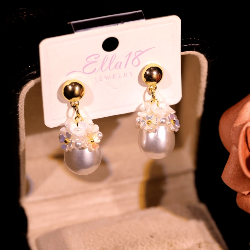 Angled view of the 14K Gold-Plated Water Drop Flower Pearl Earrings