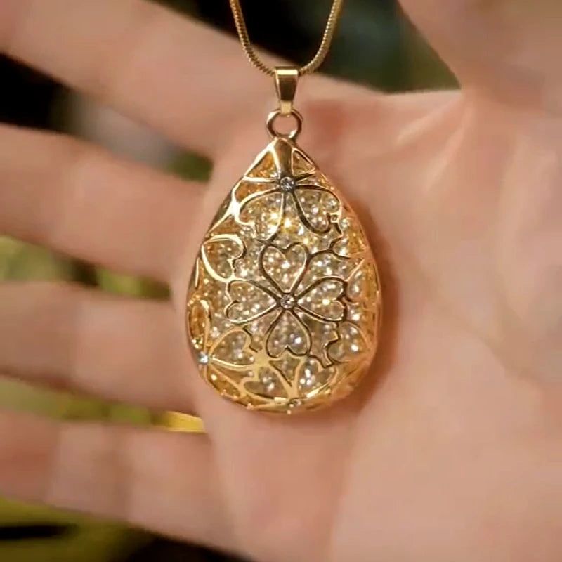 14K Gold-Plated Water Drop Hollow Flower Sweater Chain Pendant Necklace worn to showcase its length and pendant detail