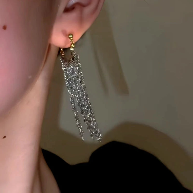 Model showcasing the dangle and style of the 14K Gold-Plated Waterfall Tassel Earrings
