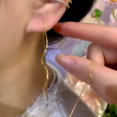 Model showcasing the dangle and style of the 14K Gold-Plated Wavy Chain Threader Earrings