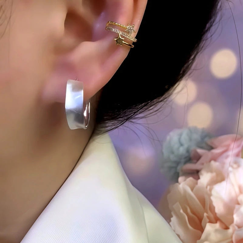 Close-up detail of the sparkling zircons and plating on the Wavy Hoop Earrings