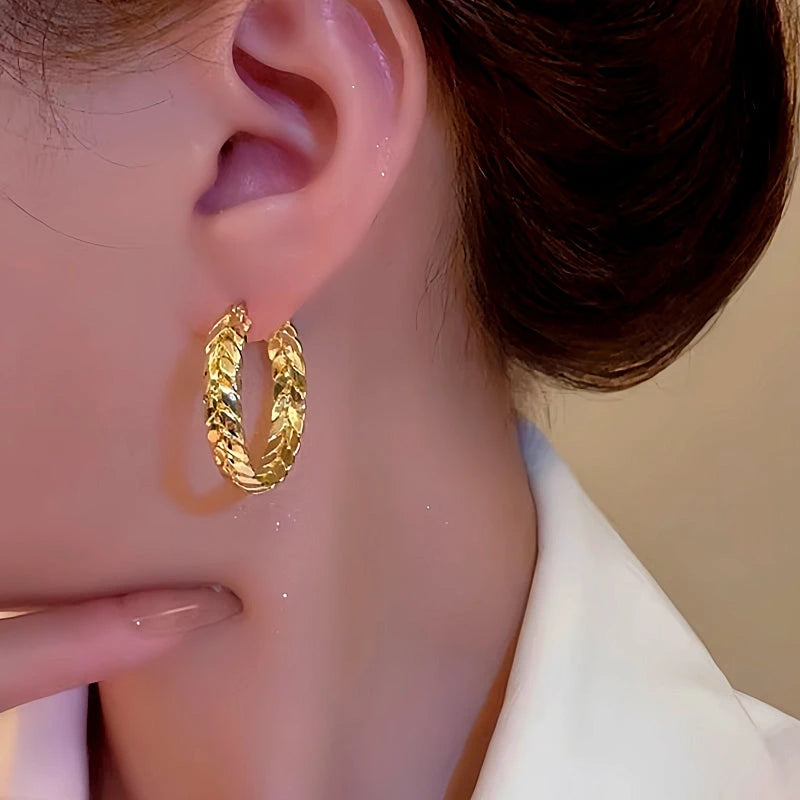 Model showcasing the dangle and style of the 14K Gold-Plated Wheat Hoop Earrings