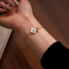 Model wearing the 14K Gold-Plated White Mother-Of-Pearl Four-Leaf Clover Bracelet to highlight its design on the wrist