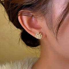 Model showcasing the dangle and style of the 14K Gold-Plated Wind Bead Earrings