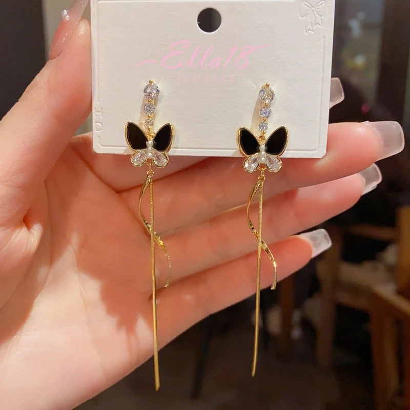 Angled view of the 14K Gold-Plated ZIrcon Butterfly Tassel Earrings