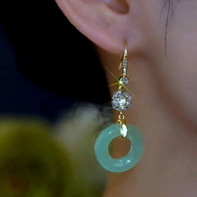 Model showcasing the dangle and style of the 14K Gold-Plated Zircon Ancient Style Peaceful Ear Hook Earrings