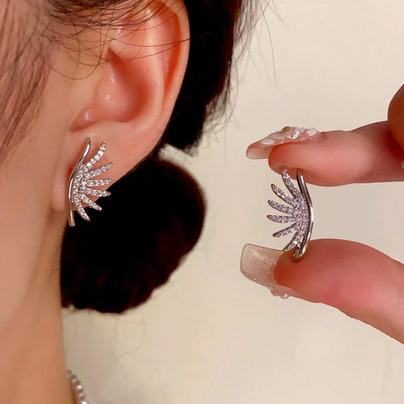 Model showcasing the dangle and style of the 14K Gold-Plated Zircon Angel Wings Earrings