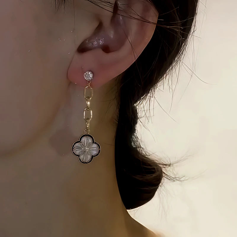 Model showcasing the dangle and style of the 14K Gold-Plated Zircon Asymmetrical Four-Leaf Flower Earring