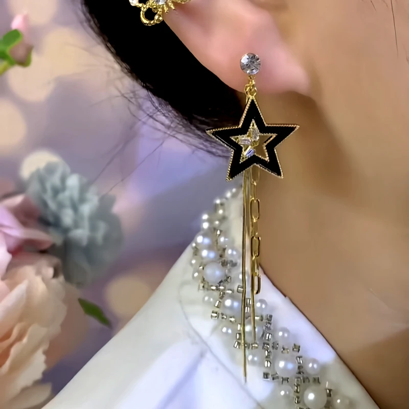 Close-up detail of the sparkling zircons and plating on the Asymmetrical Star Earrings