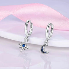 Model showcasing the dangle and style of the 14K Gold-Plated Zircon Asymmetrical Star Sun Earrings