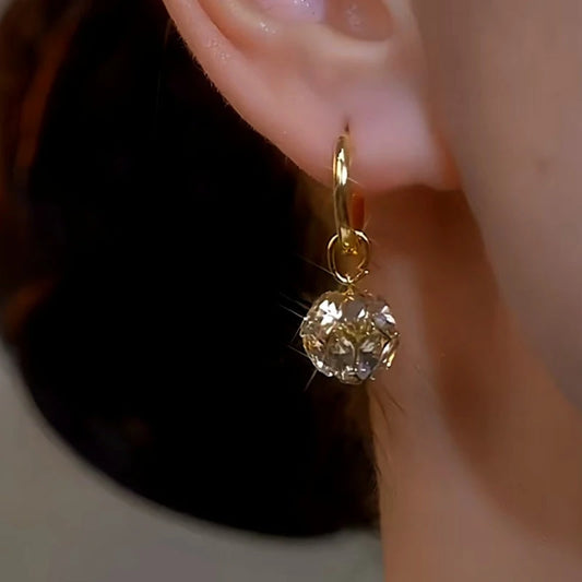 Model showcasing the dangle and style of the 14K Gold-Plated Zircon Ball Earrings