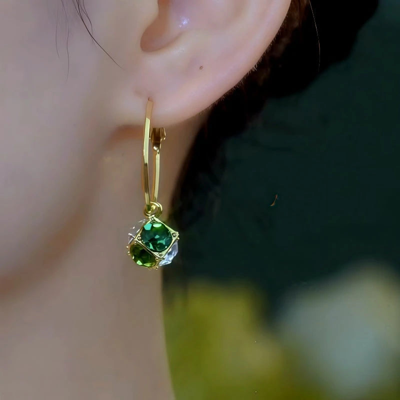 Model showcasing the dangle and style of the 14K Gold-Plated Zircon Ball Tassel Earrings