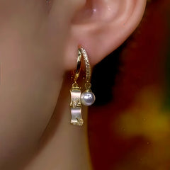 Model showcasing the dangle and style of the 14K Gold-Plated Zircon Bamboo Pearl Earrings