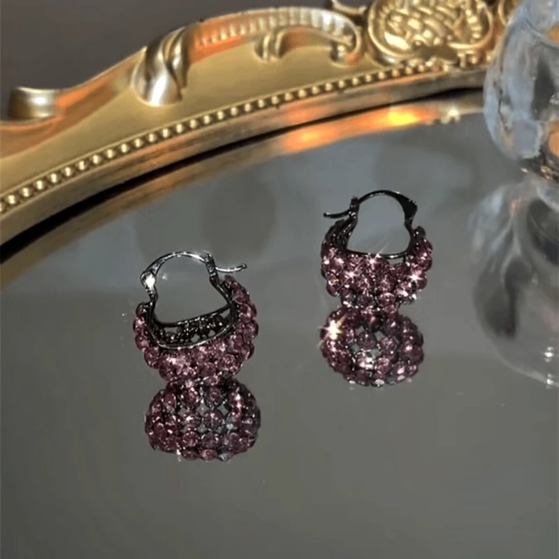 Close-up detail of the sparkling zircons and plating on the Basket Earrings