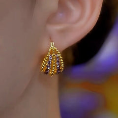 Close-up detail of the sparkling zircons and plating on the Basket Earrings