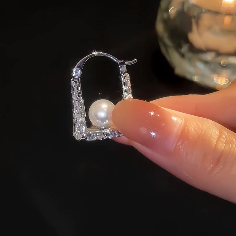 Angled view of the 14K Gold-Plated Zircon Bead Handnbag Earrings