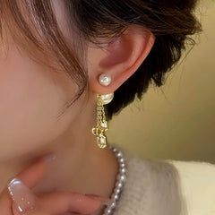 Model showcasing the dangle and style of the 14K Gold-Plated Zircon Bead Tassel Earrings