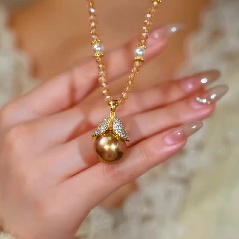 Close-up of the pendant and clasp on the Leaf Bead Necklace
