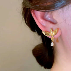 Model showcasing the dangle and style of the 14K Gold-Plated Zircon Bird Earrings