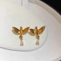 Close-up detail of the sparkling zircons and plating on the Gold Bird Earrings