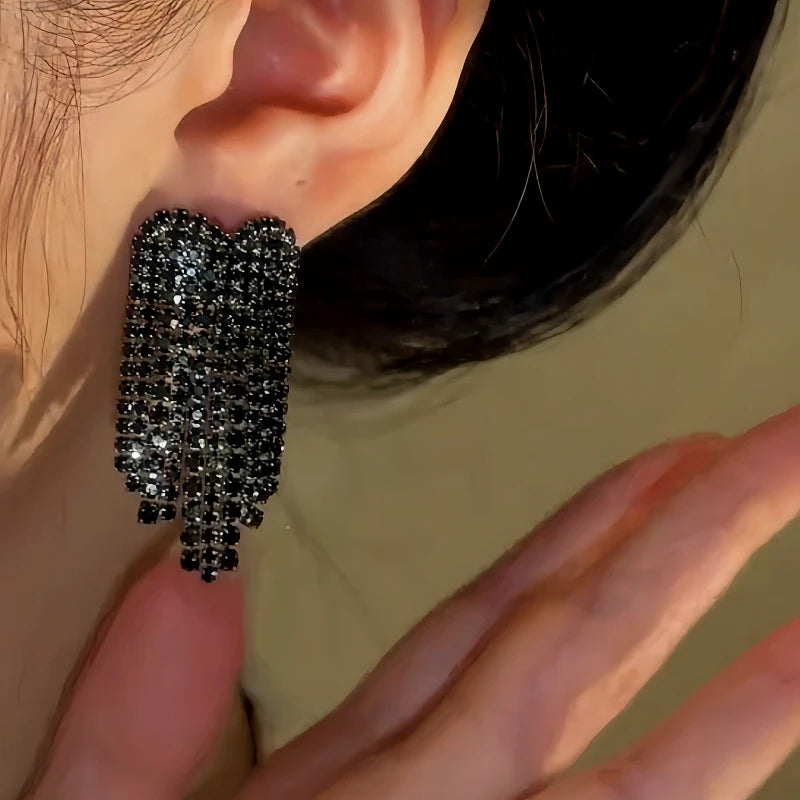 Close-up detail of the sparkling zircons and plating on the Heart Tassel Earrings