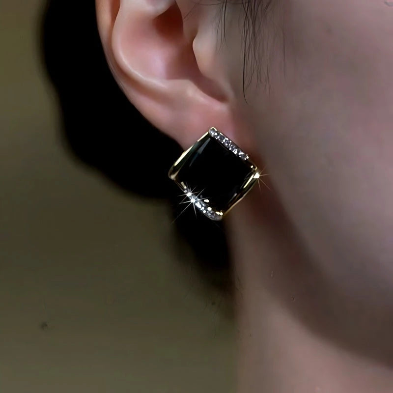 Model showcasing the dangle and style of the 14K Gold-Plated Zircon Black Diamond Stud Earrings