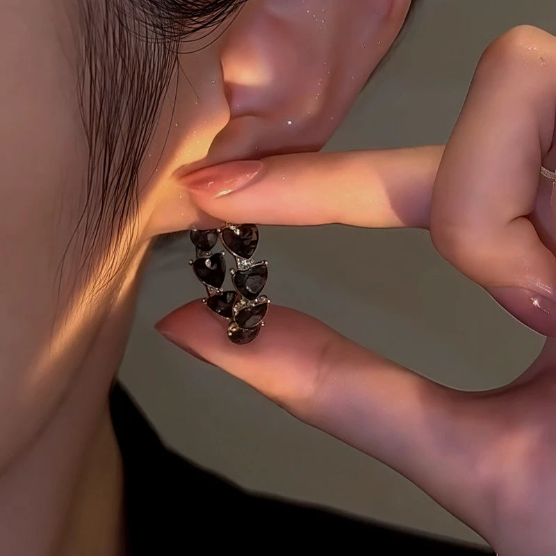 Close-up detail of the sparkling zircons and plating on the Heart Hoop Earrings
