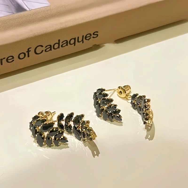 Angled view of the 14K Gold-Plated Zircon Black Leaf Earrings