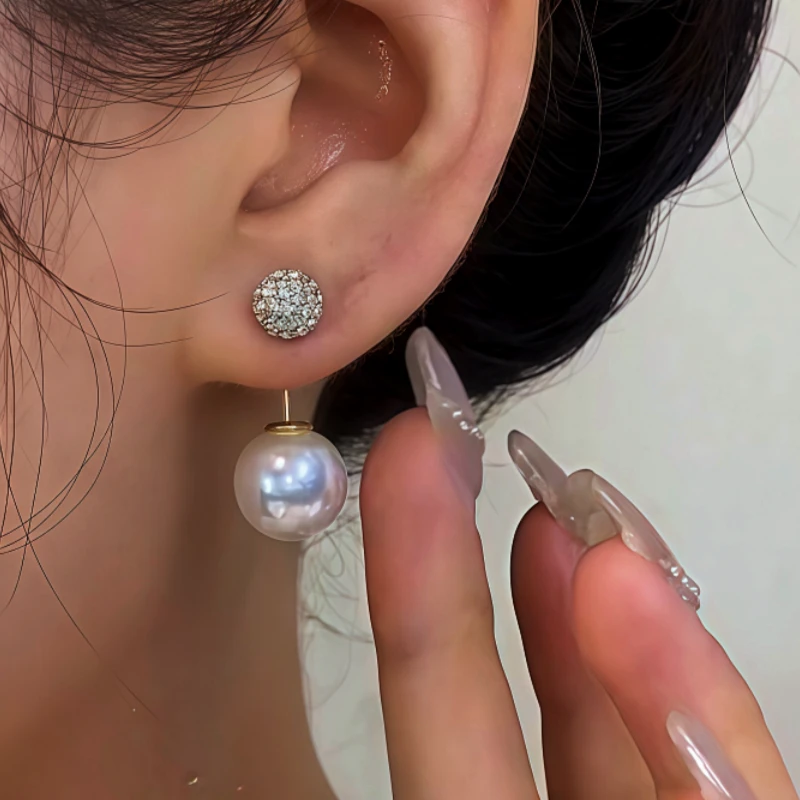 Model showcasing the dangle and style of the 14K Gold-Plated Zircon Bling Ball Pearl Earrings