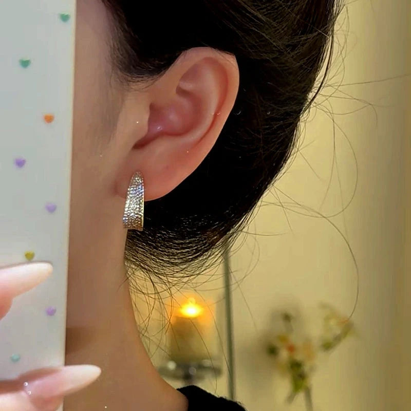 Close-up detail of the sparkling zircons and plating on the C-Shaped Earrings