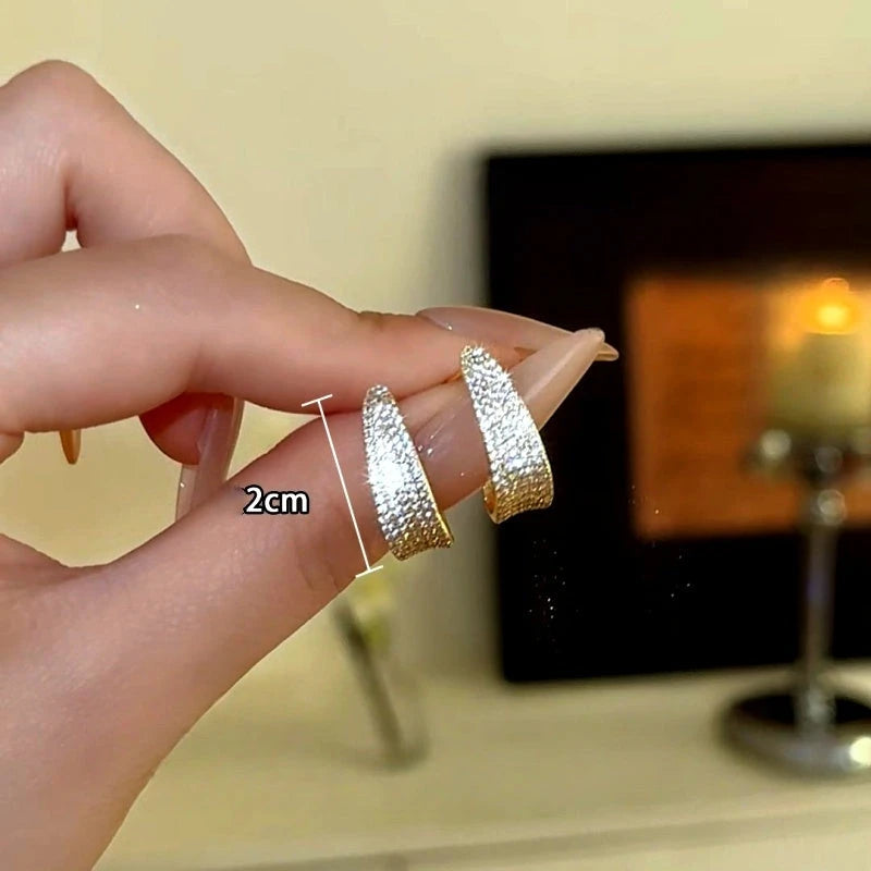 Angled view of the 14K Gold-Plated Zircon Bling Bling C-Shaped Earrings