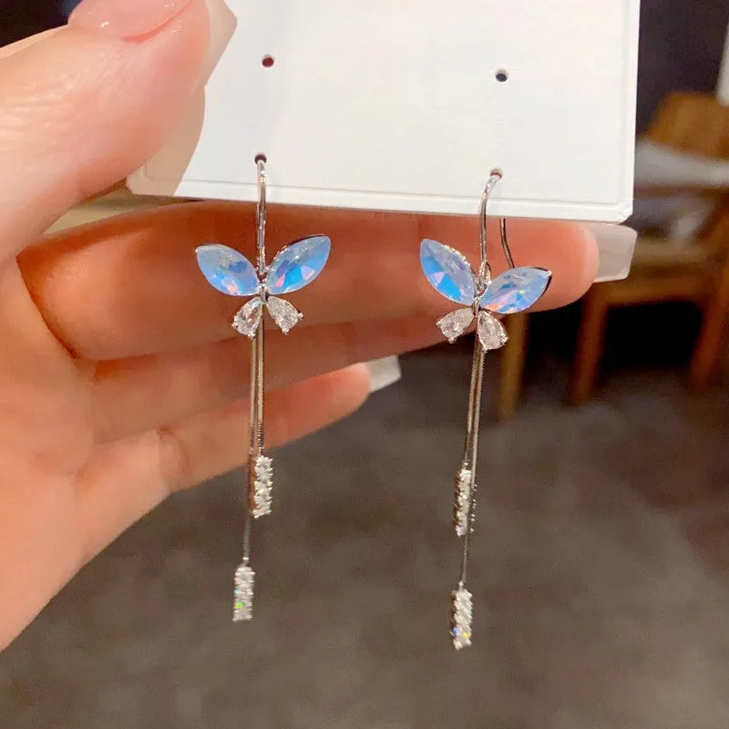 Model showcasing the dangle and style of the 14K Gold-Plated Zircon Blue Butterfly Ear Hook Tassel Earrings