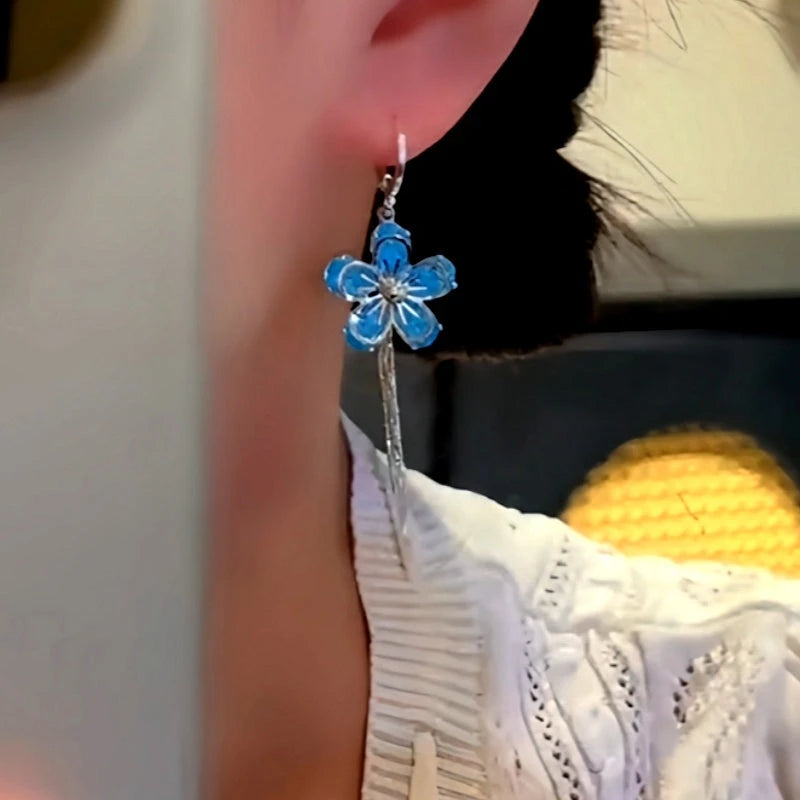 Model showcasing the dangle and style of the 14K Gold-Plated Zircon Blue Flower Tassel Earrings