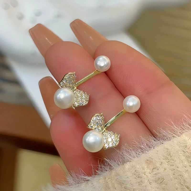 Angled view of the 14K Gold-Plated Zircon Bow Bead Jacket Earrings