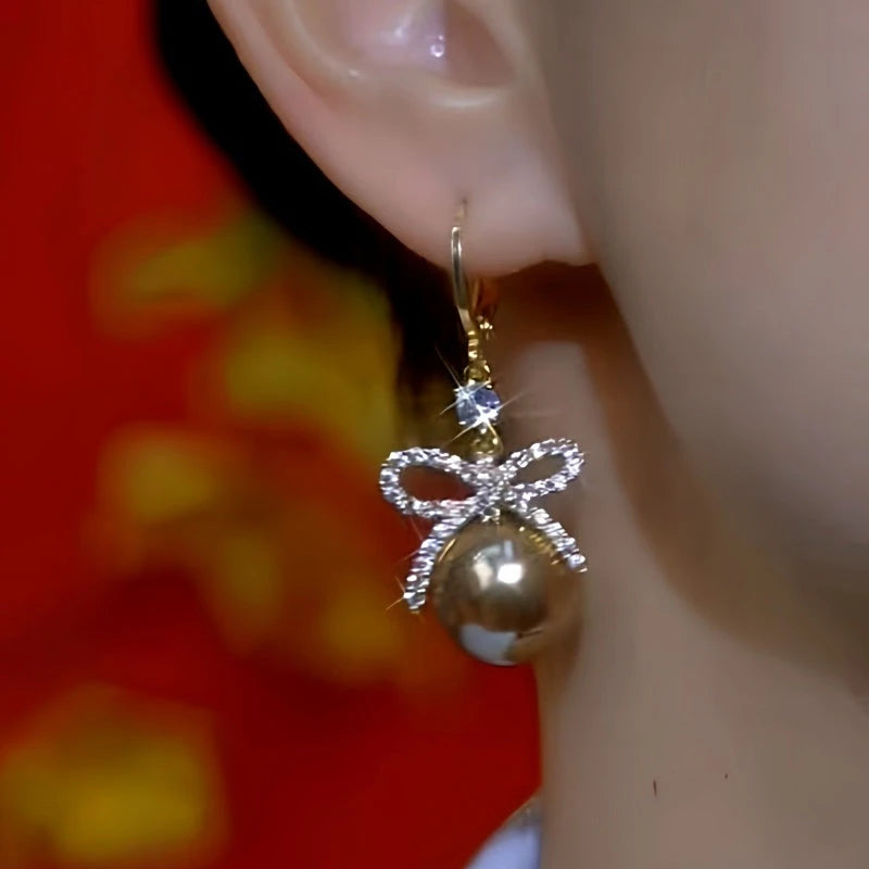 Close-up detail of the sparkling zircons and plating on the Bow Pearl Earrings