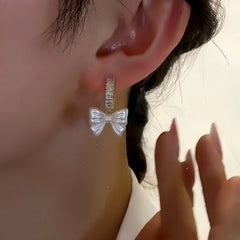 Close-up detail of the sparkling zircons and plating on the Zircon Bow Earrings
