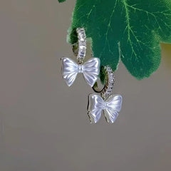 Angled view of the 14K Gold-Plated Zircon Bow Earrings