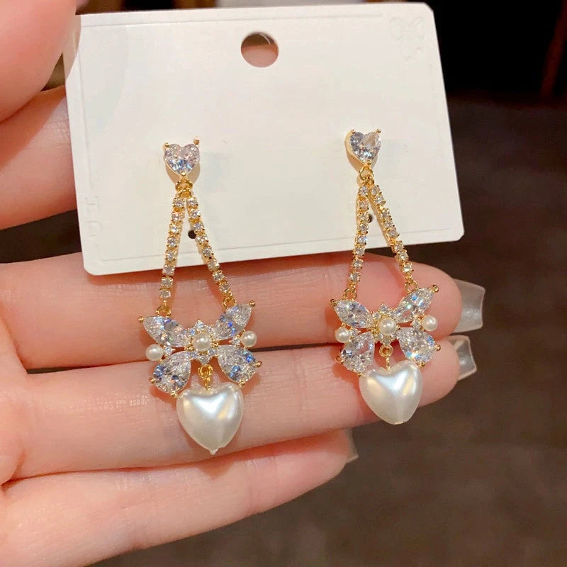 Close-up detail of the sparkling zircons and plating on the Pearl Heart Earrings
