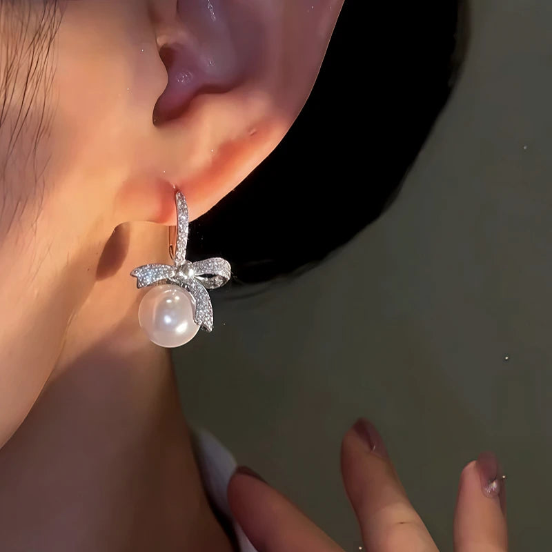 Close-up detail of the sparkling zircons and plating on the Bow Pearl Earrings