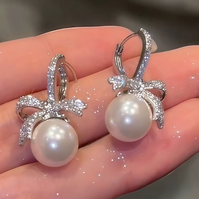 Angled view of the 14K Gold-Plated Zircon Bow Pearl Earrings