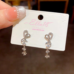 Angled view of the 14K Gold-Plated Zircon Bow Tassel Earrings