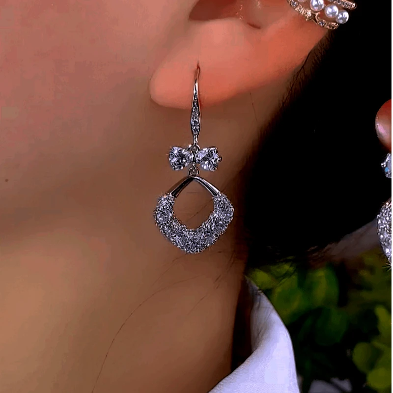 Angled view of the 14K Gold-Plated Zircon Bow Water Drop Ear Hook Earrings