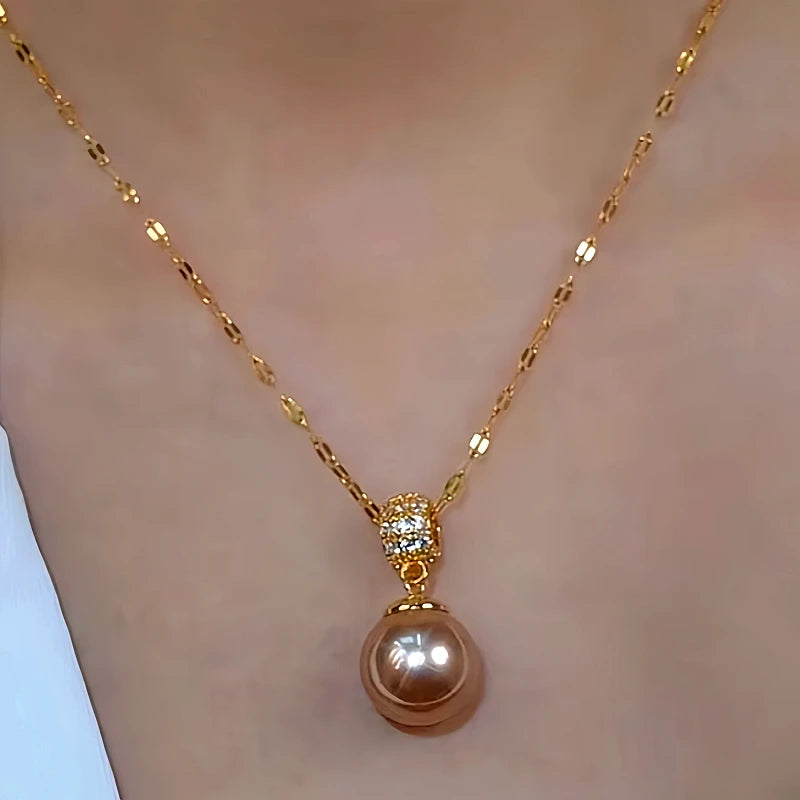 Model showcasing the dangle and style of the 14K Gold-Plated Zircon Brown Pearl Earrings And Necklace