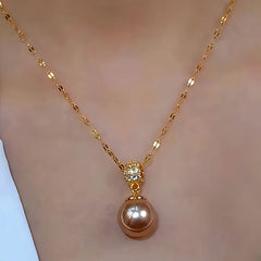 Model showcasing the dangle and style of the 14K Gold-Plated Zircon Brown Pearl Earrings And Necklace