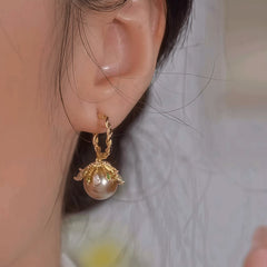 Close-up detail of the sparkling zircons and plating on the Drop Pearl Earrings