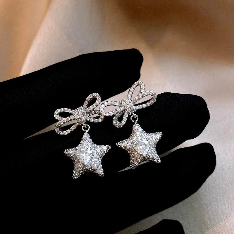 Angled view of the 14K Gold-Plated Zircon Butterfly Bow Star Earrings